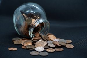 A round jar of pennies spills over