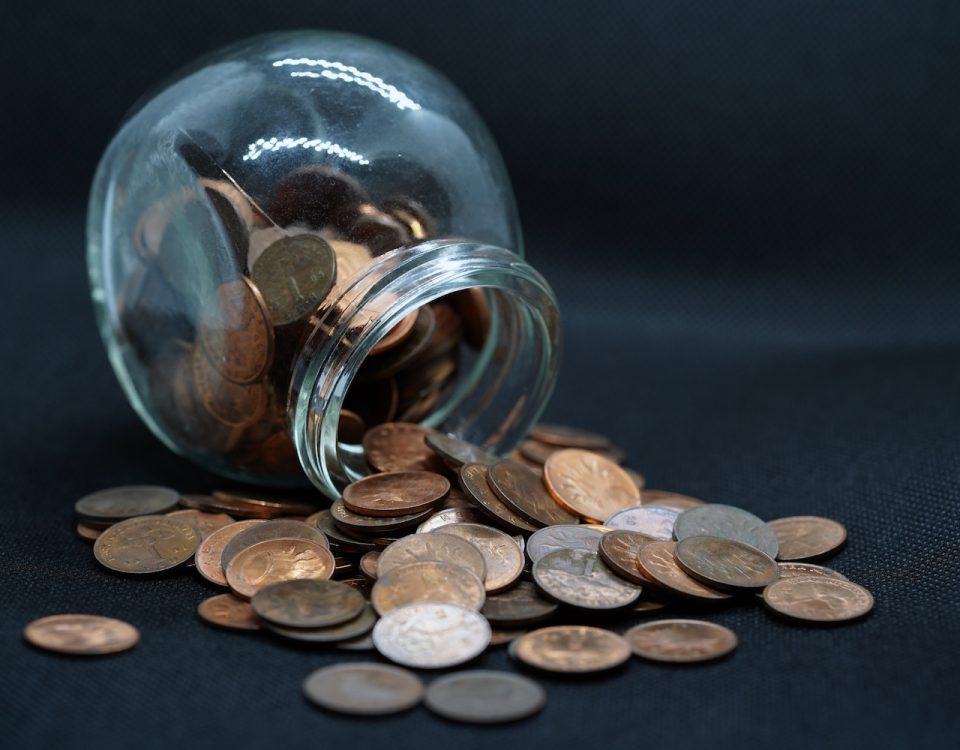 A round jar of pennies spills over