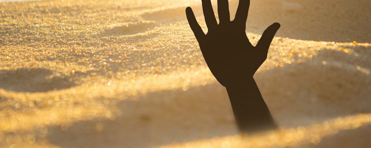 hand reaching out of quicksand