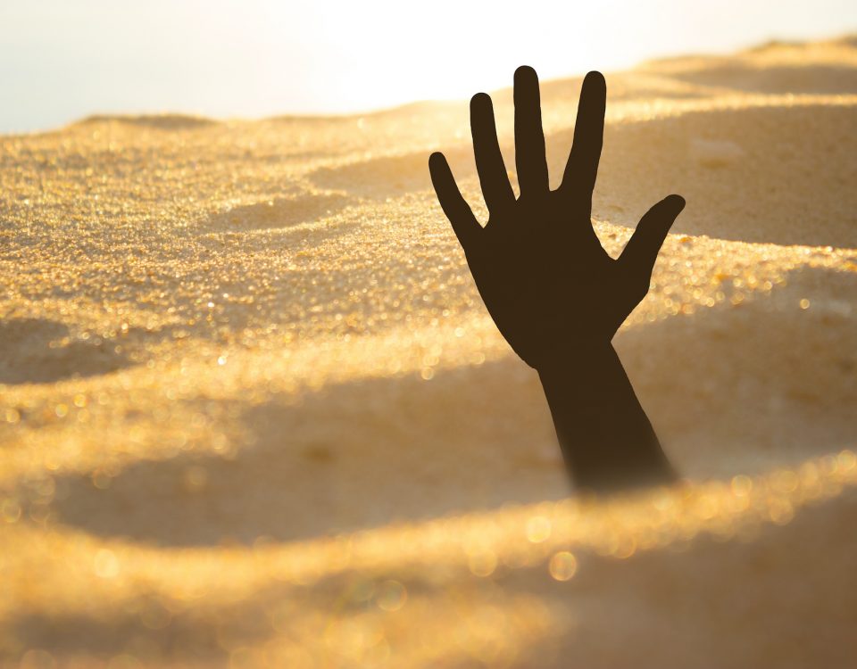 hand reaching out of quicksand