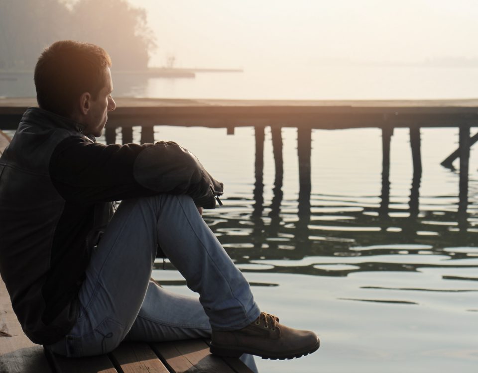 Man looking at lake in contemplation